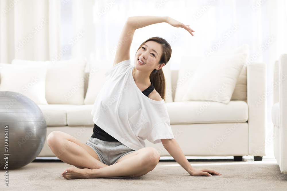 Young Chinese woman practicing yoga at home Young Chinese woman practicing yoga at home