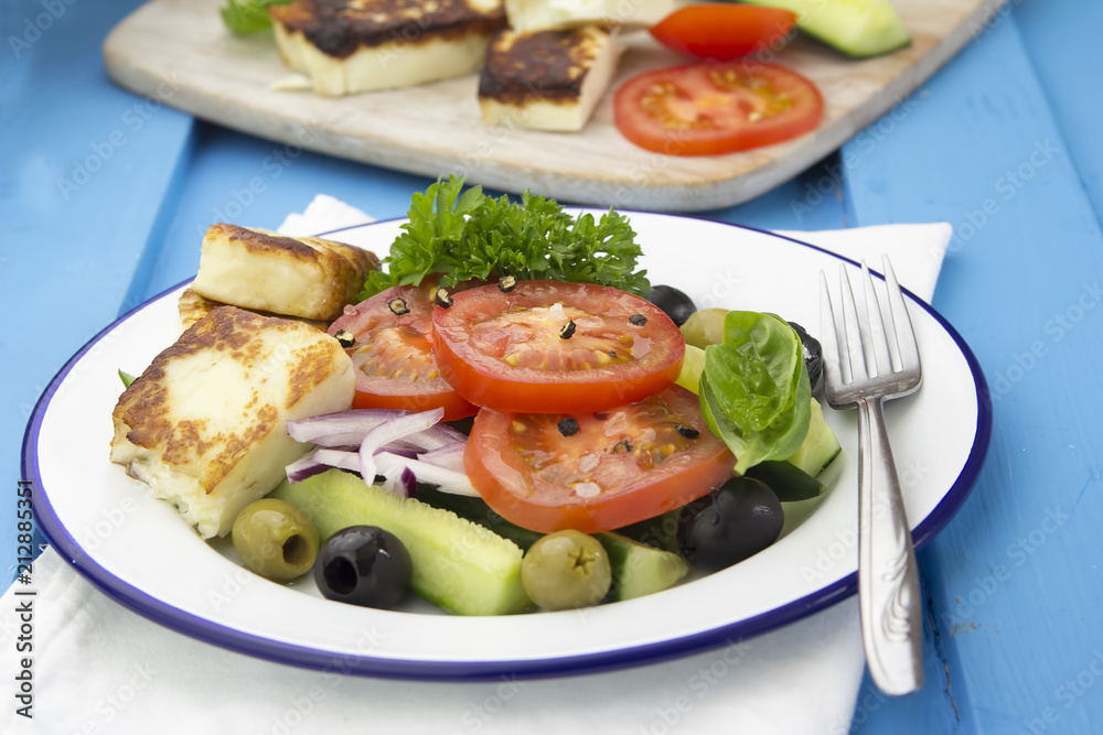 Greek salad with grilled feta cheese, cucumber, olives and tomatoes 