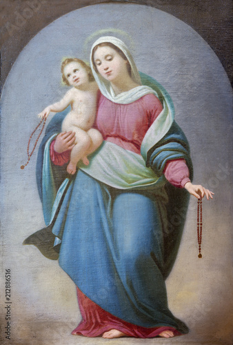 PARMA, ITALY - APRIL 17, 2018: The Painting of Madonna of Rosary in church Chiesa di Ognissanti by Giovanni Gaibazzi (1808 – 1888). photo