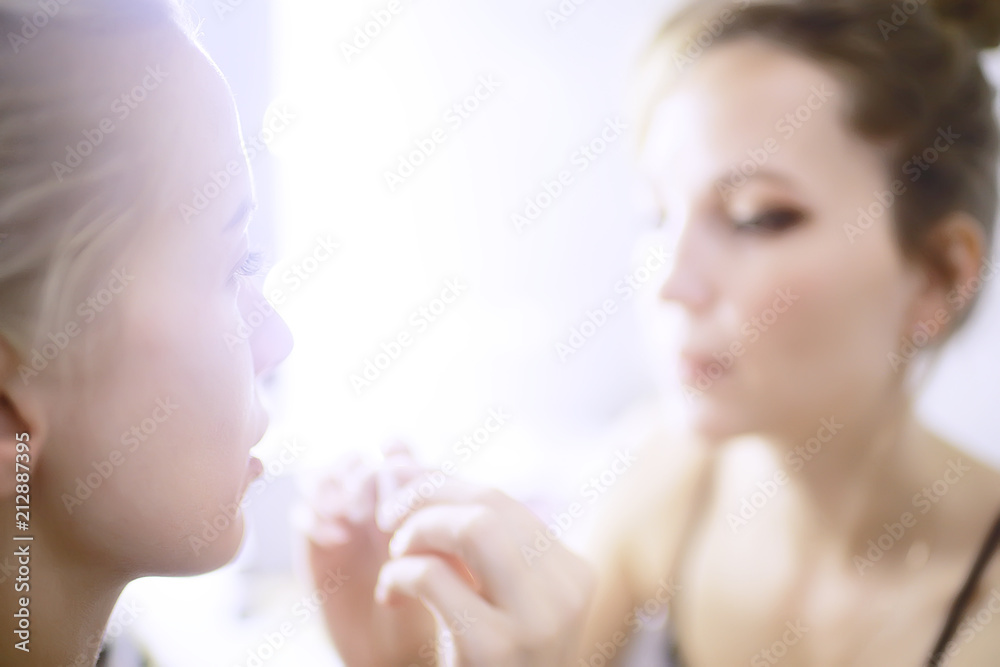 professional make-up in the beauty salon / master makes a professional fresh summer make-up of a beautiful model in the salon professional make-up in the beauty salon / master makes a professional fresh summer make-up of a beautiful model in the salon