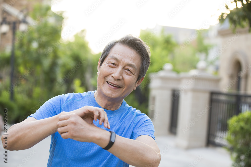 Happy senior man standing outdoors Happy senior man standing outdoors