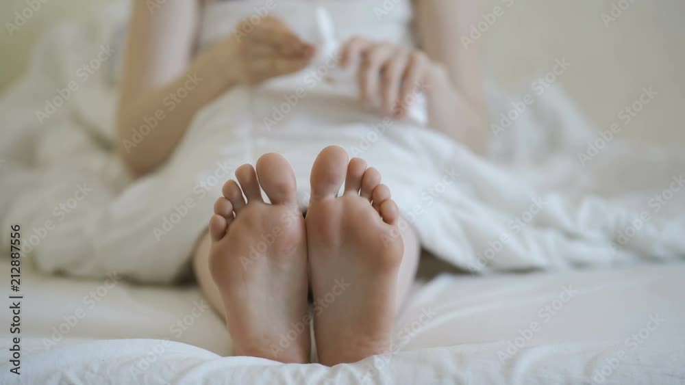 Woman applying cosmetic foot cream, doing feet massage, close up. Woman applying cosmetic foot cream, doing feet massage, close up.