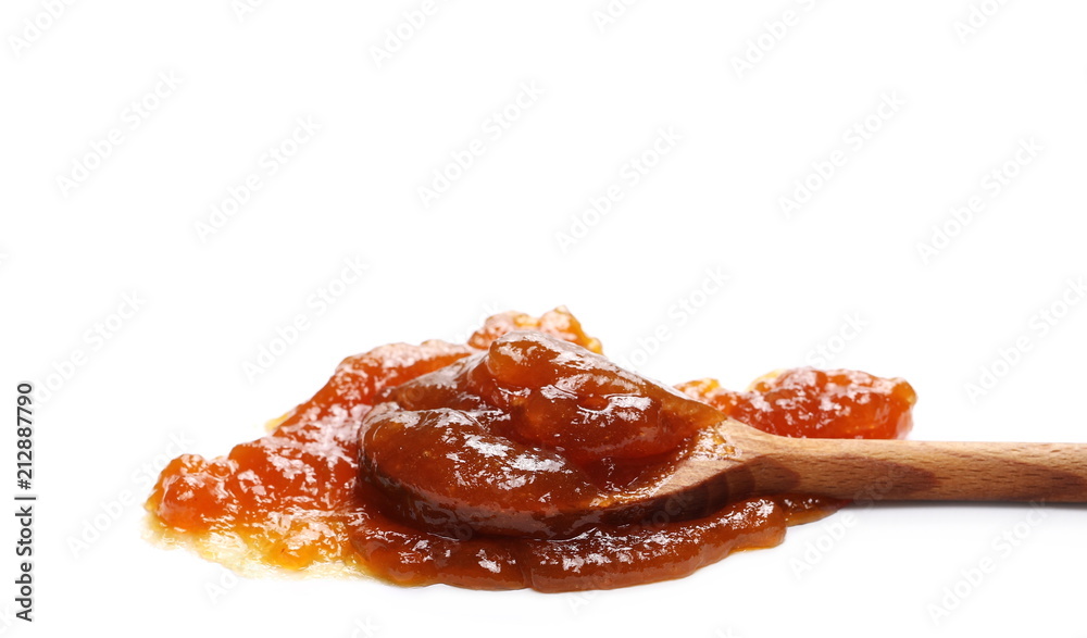 Peach jam, marmalade with wooden spoon isolated on white background and texture Peach jam, marmalade with wooden spoon isolated on white background and texture