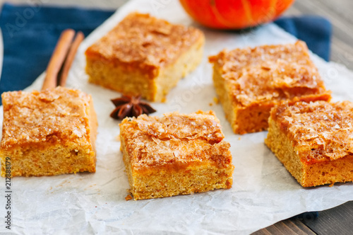 Pumpkin cornmeal bars with spices on a wooden background. Close up.