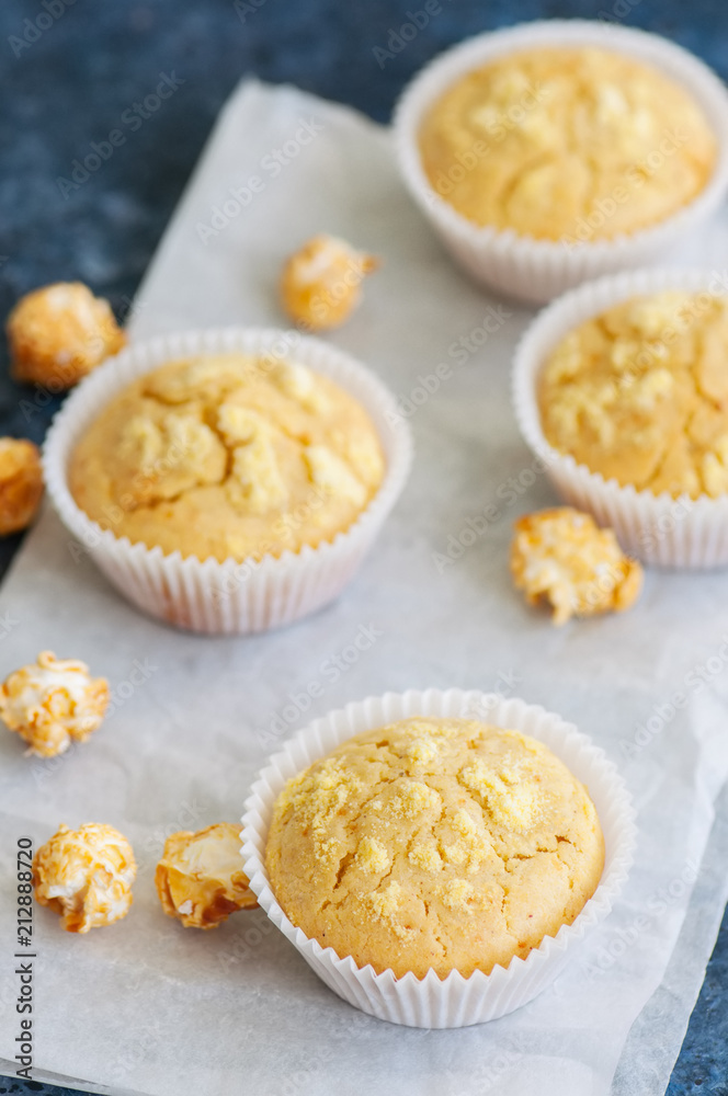 Homemade cornbread muffins on a blue stone background. Homemade cornbread muffins on a blue stone background.