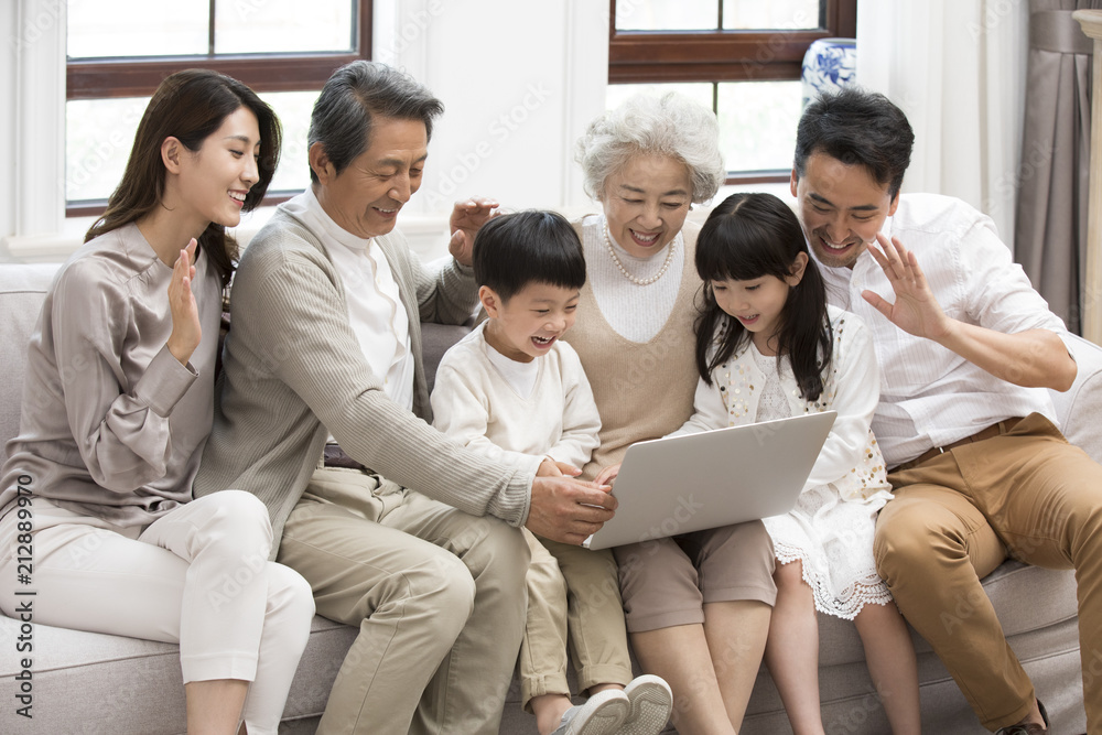 Happy Chinese family using laptop for video chatting Happy Chinese family using laptop for video chatting