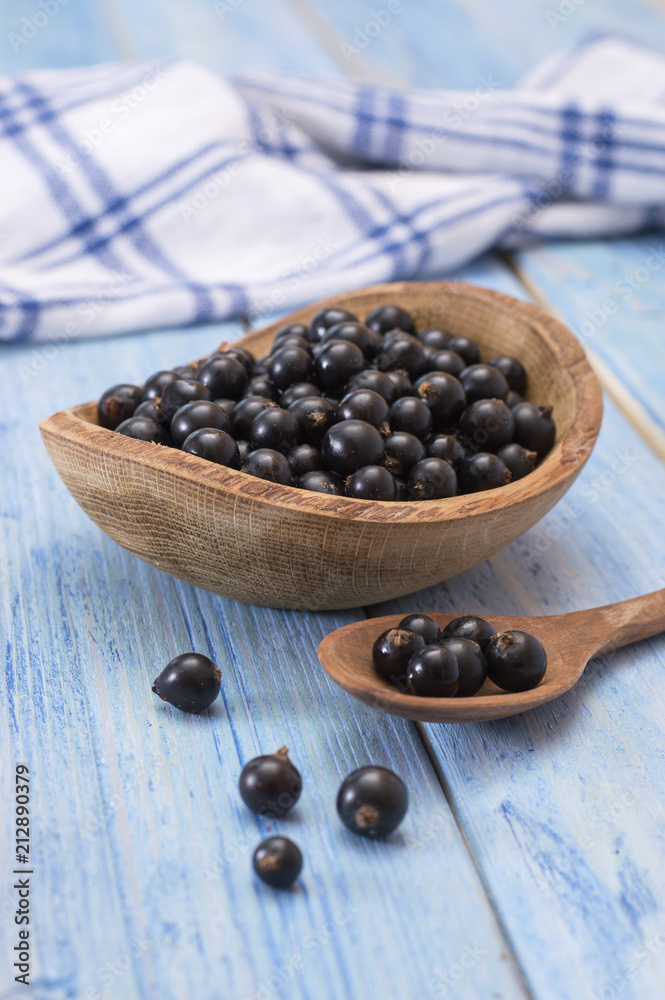 black currant on a wooden table. 