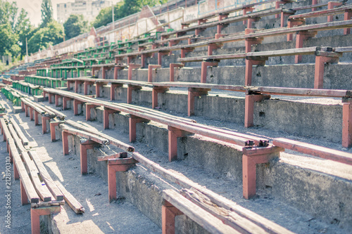 Old destroyed rows of seats of an abandoned stadium.
