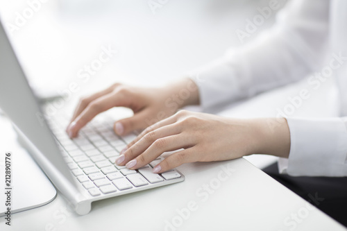 Young Chinese businesswoman using computer in office photo