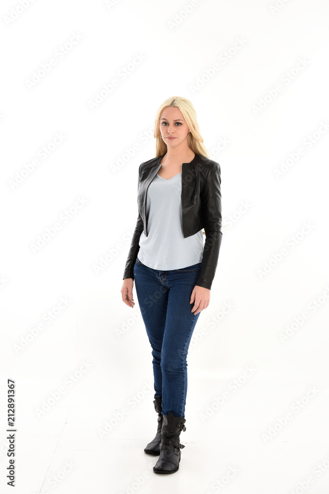 full length portrait of blonde girl wearing casual blue shirt and leather jacket. standing pose, isolated on white studio background. full length portrait of blonde girl wearing casual blue shirt and leather jacket. standing pose, isolated on white studio background.