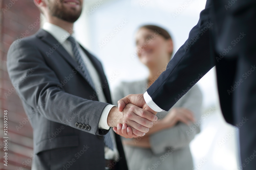 closeup of handshake of business partners closeup of handshake of business partners