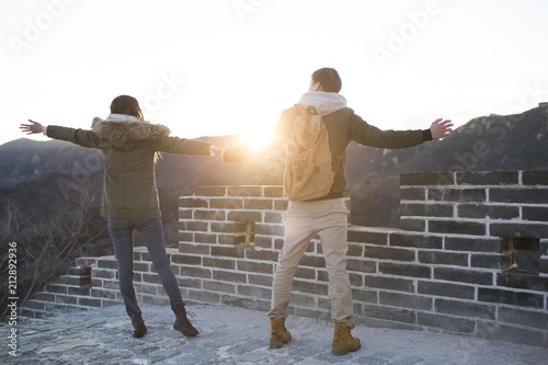 Happy young Chinese couple enjoying winter outing on the Great Wall
