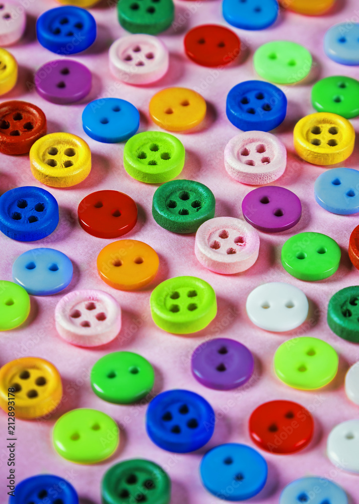 buttons of different colors on a pink background. Pastel shades buttons of different colors on a pink background. Pastel shades