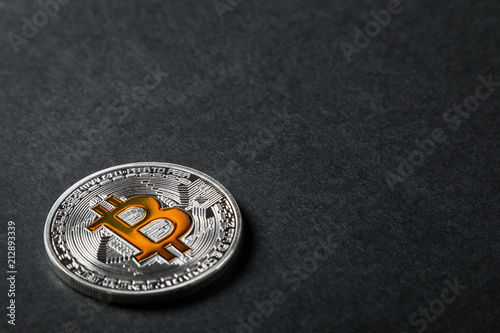 bitcoin coin on a black background. bitcoin is the most popular cryptocurrency in the world. photo