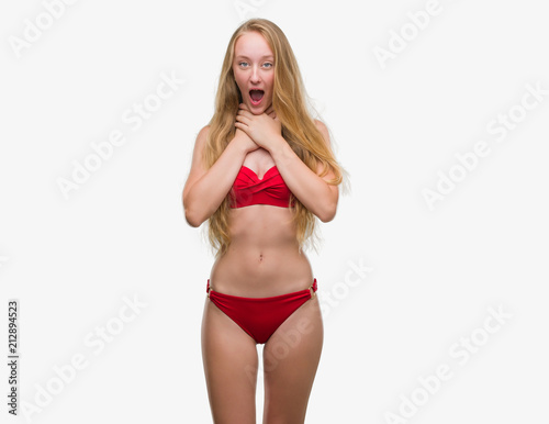 Blonde teenager woman wearing red bikini shouting and suffocate because painful strangle. Health problem. Asphyxiate and suicide concept.