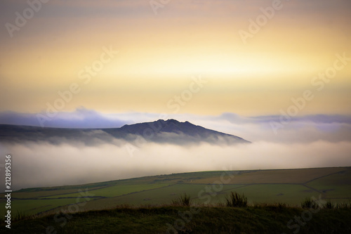 Scenic landscape of Pembrokeshire coast, Uk.Sunrise over misty fields.
