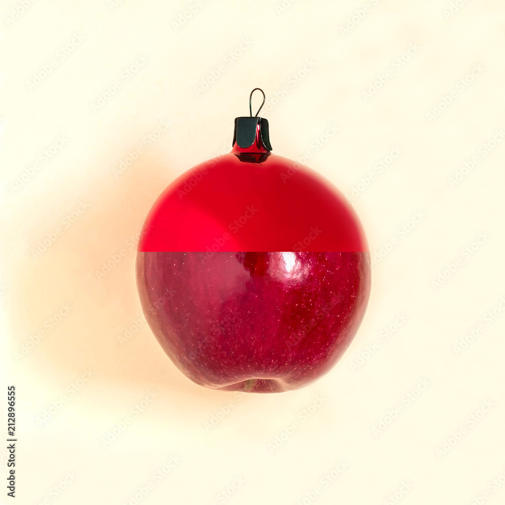 Christmas ball and apple are connected on yellow background Christmas ball and apple are connected on yellow background