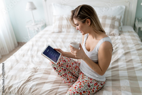 Young beautiful blonde woman using digital tablet