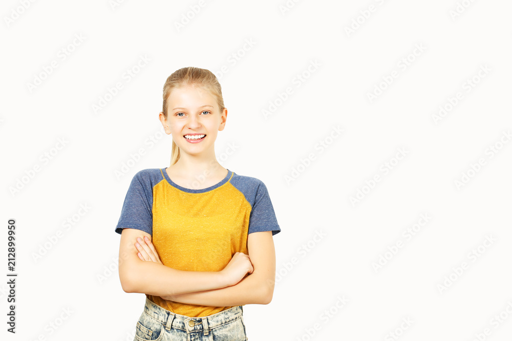 Young beautiful teenage girl with blond hair in ponytail wearing yellow baseball t-shirt with blue sleeves. Pretty female smiling with folded hands standing on isolated white background w/ copy space Young beautiful teenage girl with blond hair in ponytail wearing yellow baseball t-shirt with blue sleeves. Pretty female smiling with folded hands standing on isolated white background w/ copy space