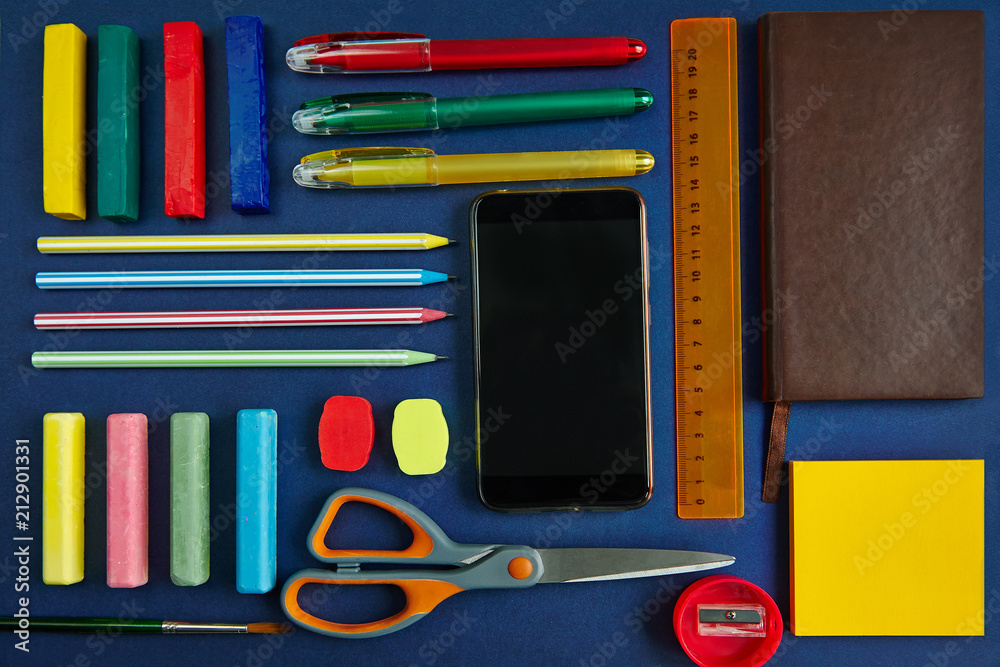 School supplies and stationery on blue background, top view School supplies and stationery on blue background, top view