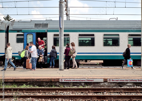 Group of people .get off the locomotive, train station, Santhià, Italy in May 19, 2018 photo