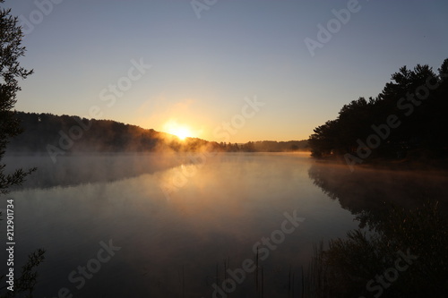 Sunrise over misty lake © ninefera