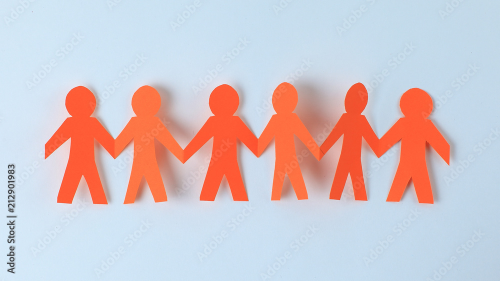 four paper men taking each other's hands four paper men taking each other's hands