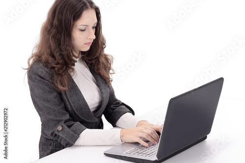 rear view.smiling businesswoman typing on laptop and looking at