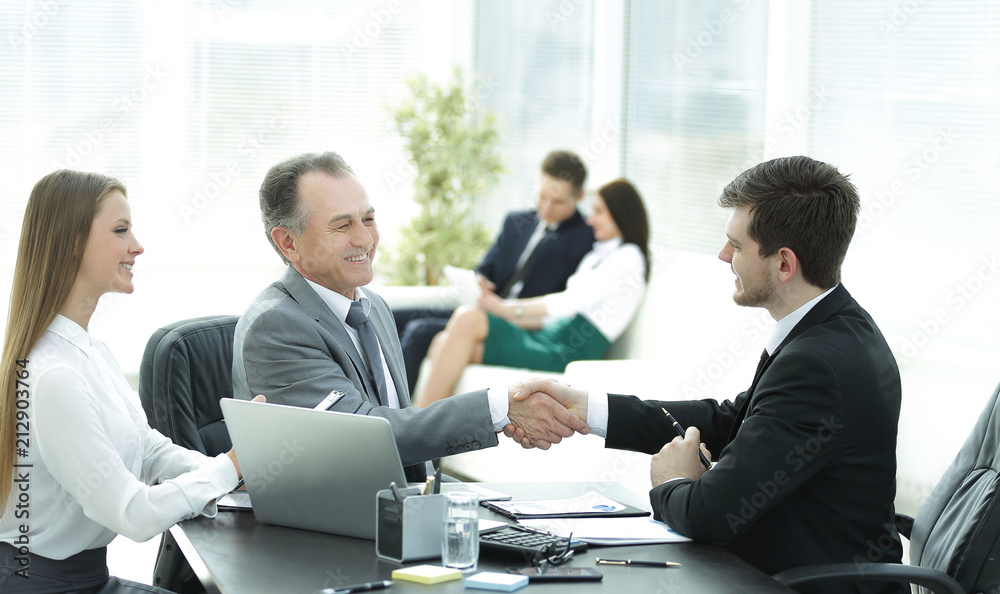 handshake business people behind a Desk in the office