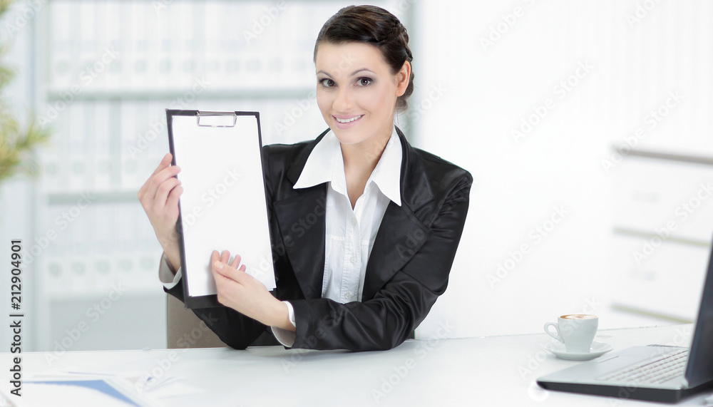 Executive business woman showing blank sheet,sitting at her Desk Executive business woman showing blank sheet,sitting at her Desk
