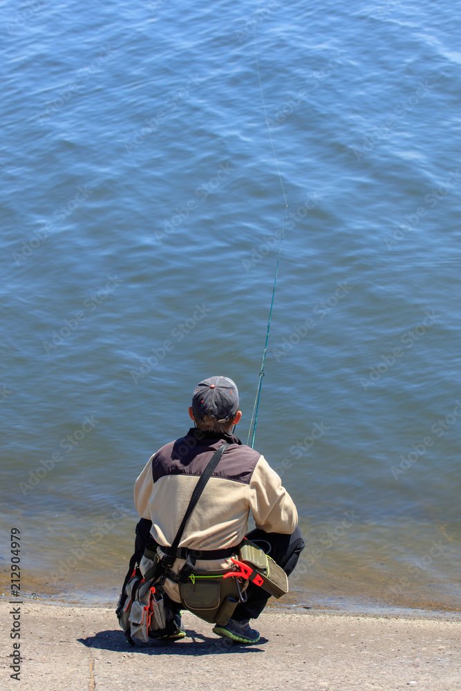 The fisherman is fishing on the lake The fisherman is fishing on the lake