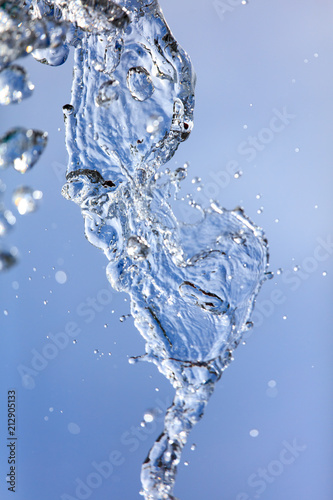 Splashing water with drops on the sky background © schankz