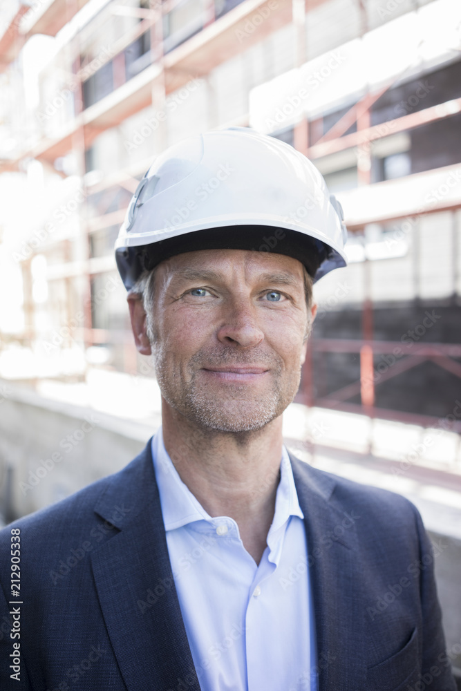 Portrait of confident architect wearing hard hat on construction site Portrait of confident architect wearing hard hat on construction site