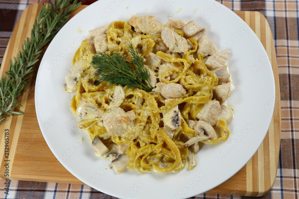 Macaroni of Carbonara with smoked sausage, bacon, sauce. Tasty lunch in the Italian restaurant with herbs, dill