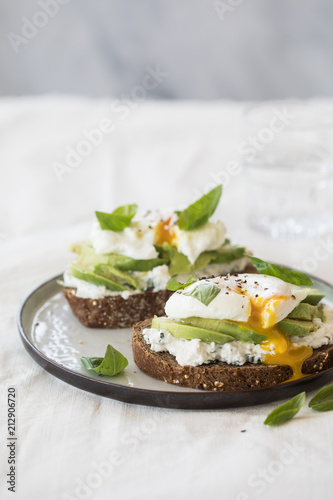 Toast with ricotta, avocado and a poached egg on top