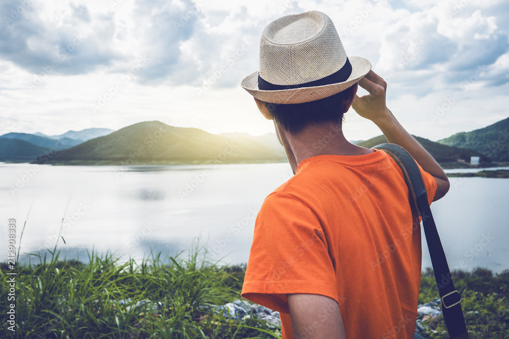 Young man traveller with reservoir and mountain sunset time. Young man traveller with reservoir and mountain sunset time.
