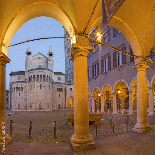 Modena - The porticoes on the Piazza Grande square at dusk with the Dome. photo