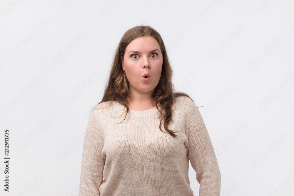 Is it really so concept. Amazed beautiful plump woman with long hair and attractive appearance looking with large eyes and opened mouth into camera. She can not belive her eyes. Is it really so concept. Amazed beautiful plump woman with long hair and attractive appearance looking with large eyes and opened mouth into camera. She can not belive her eyes.
