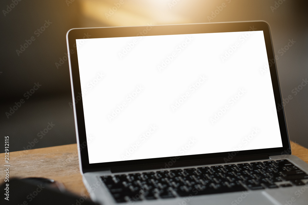 Mockup image of a businesswoman using laptop with blank white desktop screen with coffee cup on wooden table in cafe Mockup image of a businesswoman using laptop with blank white desktop screen with coffee cup on wooden table in cafe