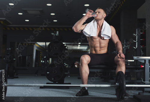 Muscular bodybuilder rest after deadlifts at gym © Prostock-studio