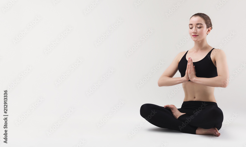 Beautiful woman doing yoga lotus pose