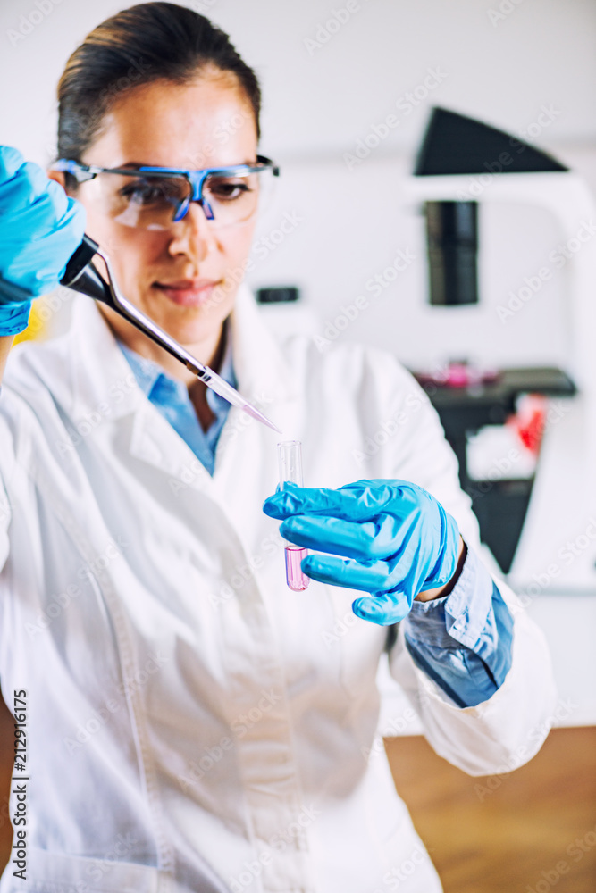 Laboratory technician with micro pipette Laboratory technician with micro pipette
