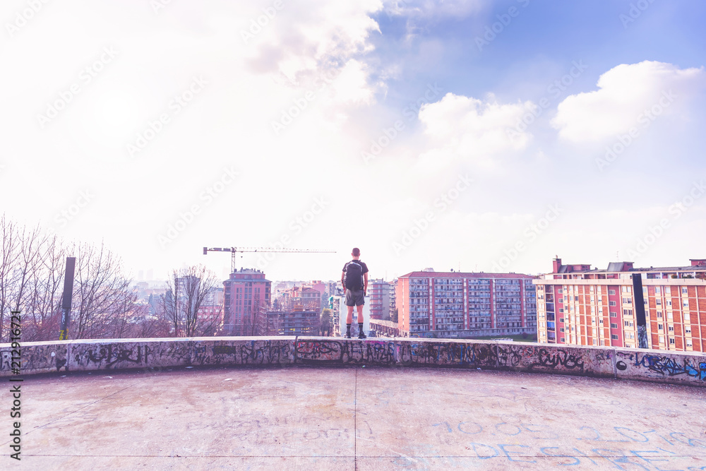Fototapeta premium Rear view young man standing getting away from it all - peace and quiet, solitude, independence concept