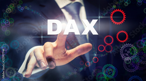 A businessman pressing a DAX button on a futuristic computer display