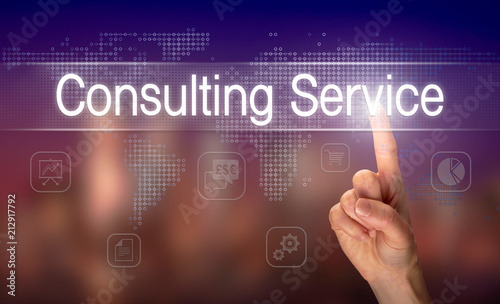 A hand selecting a Consulting Service business concept on a clear screen with a colorful blurred background.