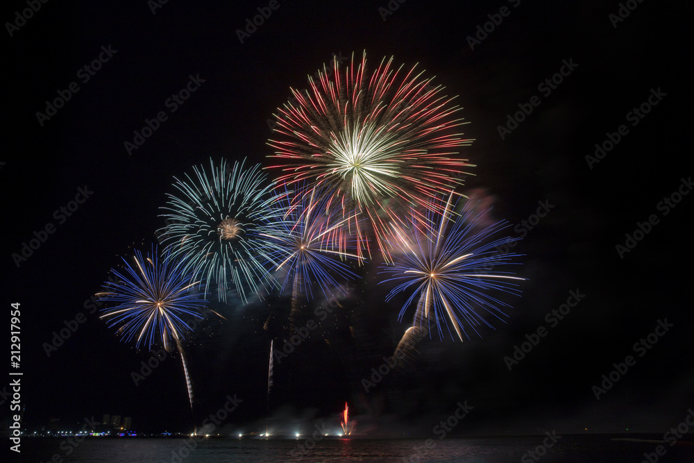 Festive beautiful colorful fireworks display on the sea beach, Amazing holiday fireworks party or any celebration event in the dark sky