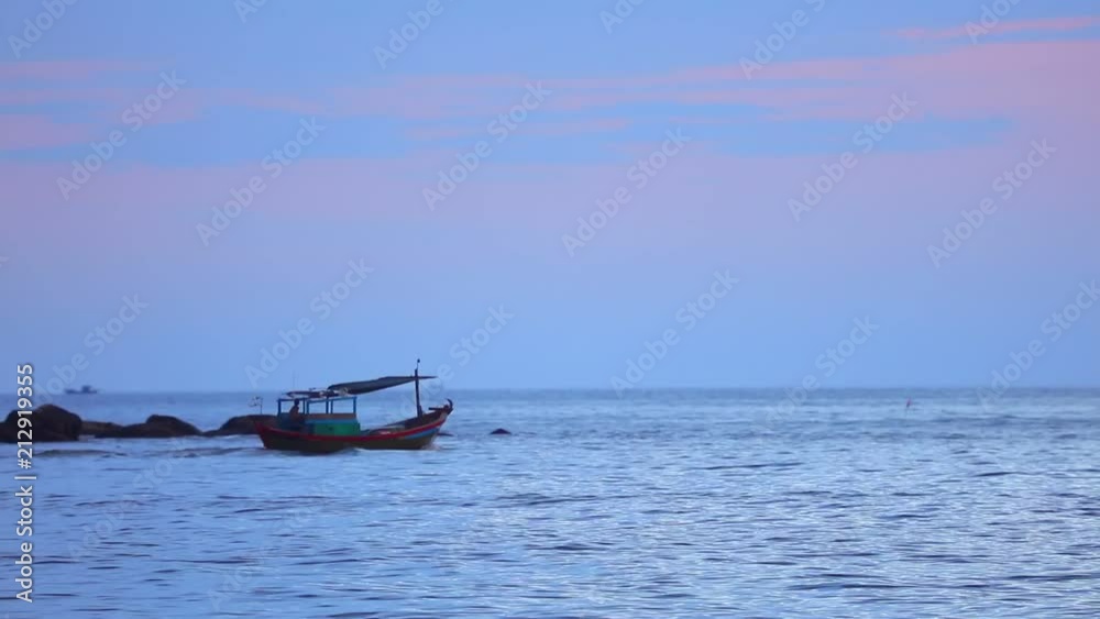 Fisherman in a small wooden fishing boat navigating across the south china sea, under tropical sunset skies high definition stock footage clip. Fisherman in a small wooden fishing boat navigating across the south china sea, under tropical sunset skies high definition stock footage clip.