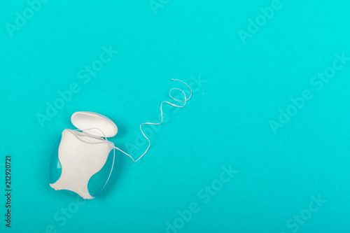 dental floss box on blue background top view