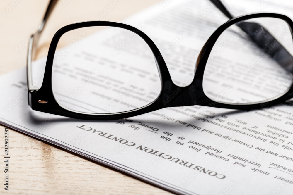Close up shot of Eyeglasses on document papers business concept Close up shot of Eyeglasses on document papers business concept