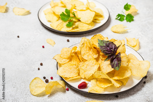 Crispy potato chips on a plate closeup